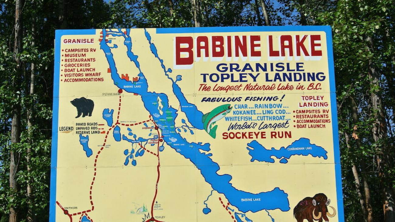 Illustrated map and signboard for Babine Lake, BC, highlighting fishing spots and attractions.